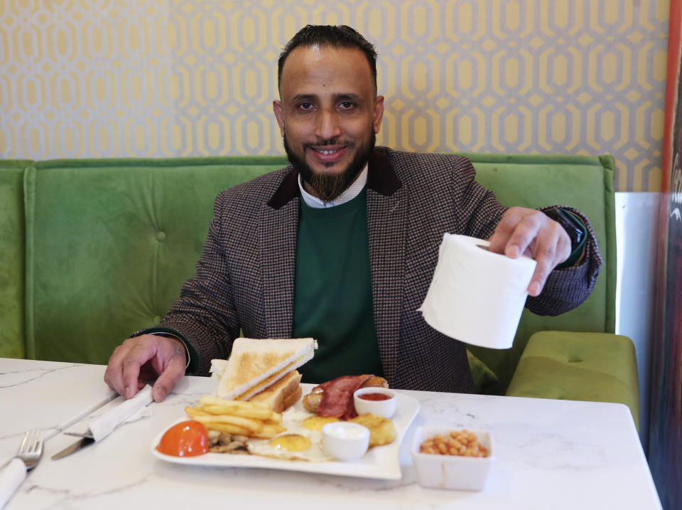 Shuhel Ahmed, owner of Cafe Zara Lounge in the Isle of Dogs, east London, with his offer to customers of a free toilet roll with every breakfast purchase. At least 36 people have now died in the UK after being diagnosed with coronavirus, after Wales confirmed its first death.