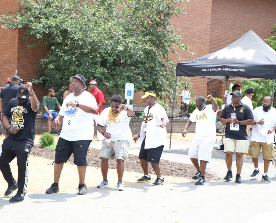 Members of the Delta Epsilon Lambda Chapter of Alpha Phi Alpha Fraternity, Inc., stroll during a Juneteenth event in East St. Louis on June 19, 2021.