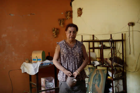 Felina, 50, an indigenous Zapotec transgender woman also know as Muxe, poses for a photo inside her house destroyed after an earthquake that struck on the southern coast of Mexico late on Thursday, in Juchitan, Mexico, September 10, 2017. Picture taken, September 10, 2017. REUTERS/Edgard Garrido