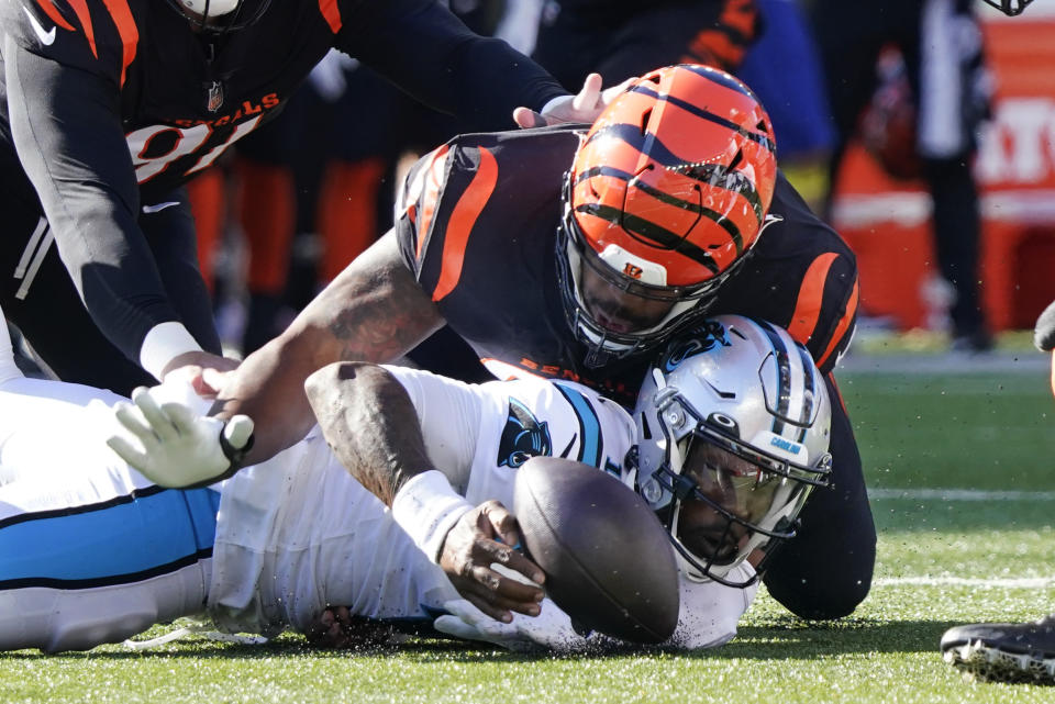 Cincinnati Bengals defensive tackle BJ Hill, top, hits Carolina Panthers quarterback PJ Walker (11), bottom, who fumbles the ball during the first half of an NFL football game, Sunday, Nov. 6, 2022, in Cincinnati. (AP Photo/Joshua A. Bickel)