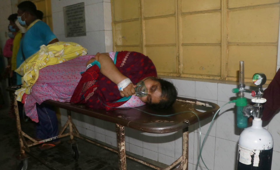 A patient receives oxygen lying on a stretcher at the Medical College Hospital in Rajshahi, 254 kilometers (158 miles) north of the capital, Dhaka, Bangladesh, June 16, 2021. Rajshahi has become one of the latest hotspots for the deadlier delta variant of the coronavirus. Bangladeshi authorities are increasingly becoming worried over the quick spread of coronavirus in about two dozen border districts close to India amid concern that the virus could devastate the crowded nation in coming weeks. (AP Photo/ Kabir Tuhin)