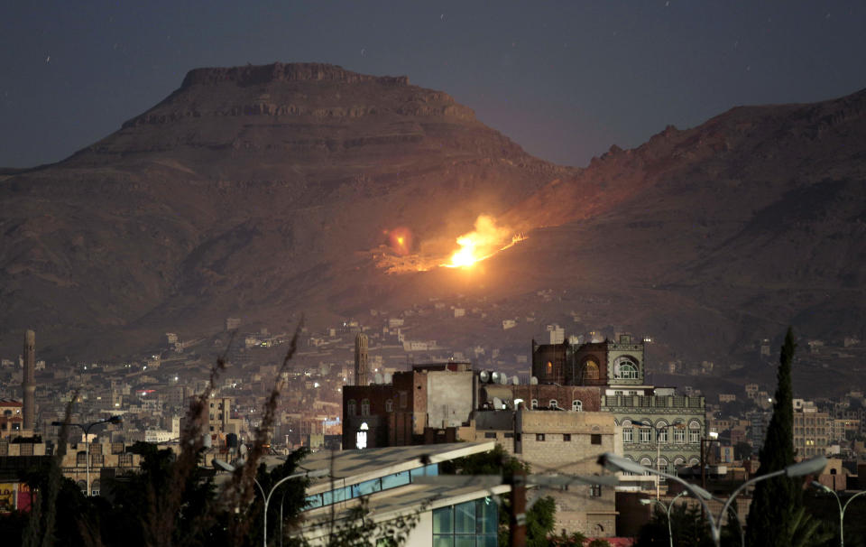 FILE - In this Oct. 14, 2016 file photo, fire and smoke rise after a Saudi-led airstrike hit a site believed to be one of the largest weapons depots on the outskirts of Yemen's capital, Sanaa. Airstrikes by Saudi Arabia and its allies in Yemen are on a pace to kill more civilians in 2018 than last year despite US claims that the coalition is working to prevent such bloodshed, a database tracking violence shows. The war, nearly four years old, may have killed as many as 80,000 people, according to the figures, not counting the untold numbers who have died of hunger in the humanitarian disaster wreaked by the conflict. (AP Photo/Hani Mohammed, File)