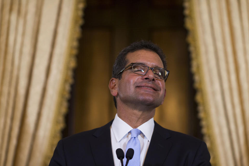 Pedro Pierluisi, sworn in as Puerto Rico's governor, smiles during a press conference in San Juan, Puerto Rico, Friday, Aug. 2, 2019. Departing Puerto Rico Gov. Ricardo Rossello resigned as promised on Friday and swore in Pierluisi, a veteran politician as his replacement, a move certain to throw the U.S. territory into a period of political chaos that will be fought out in court. (AP Photo/Dennis M. Rivera Pichardo)