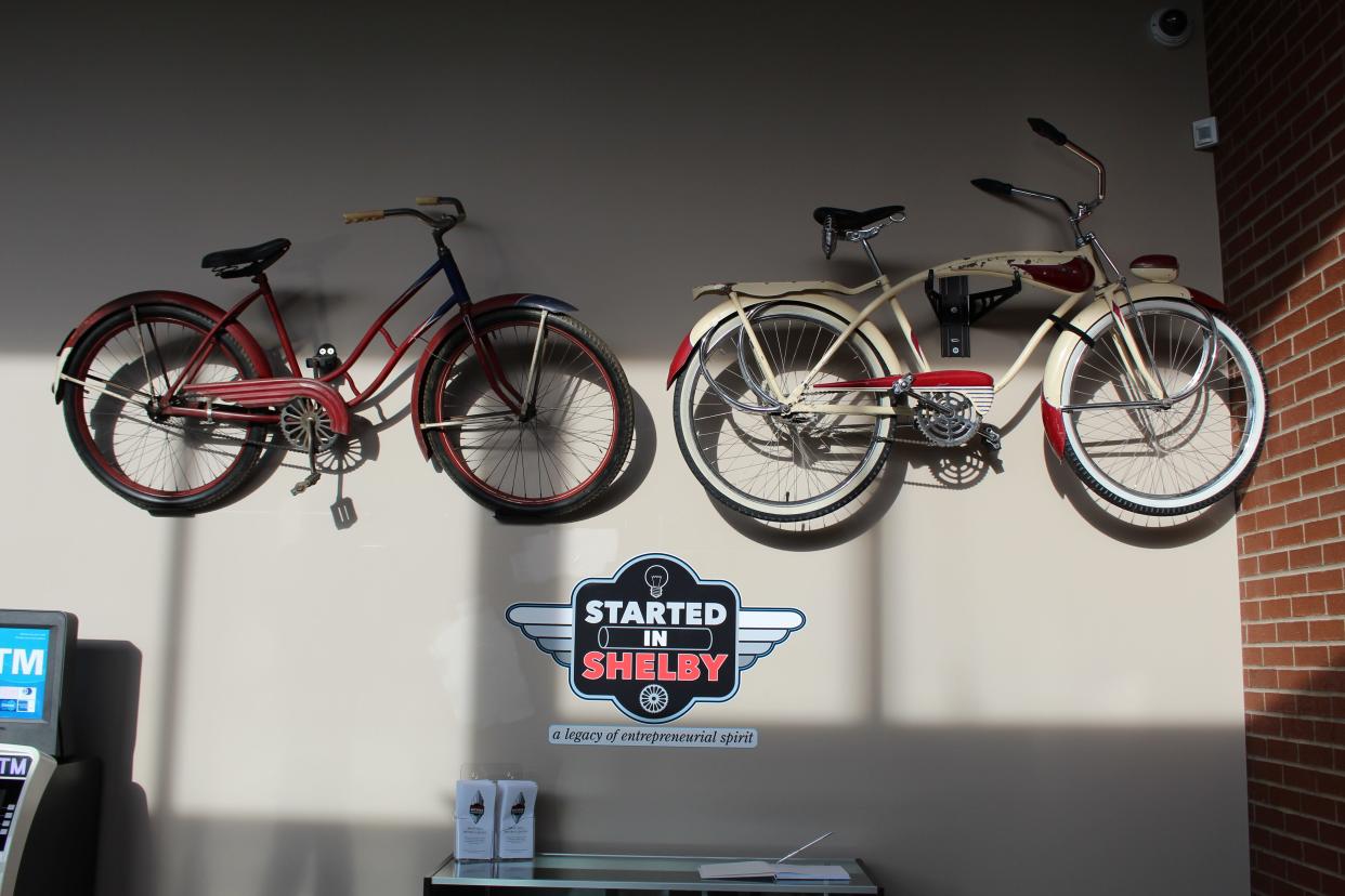 Two antique bicycles hang on the wall at the new Shelby Bicycle Museum in the Shelby Justice Center.