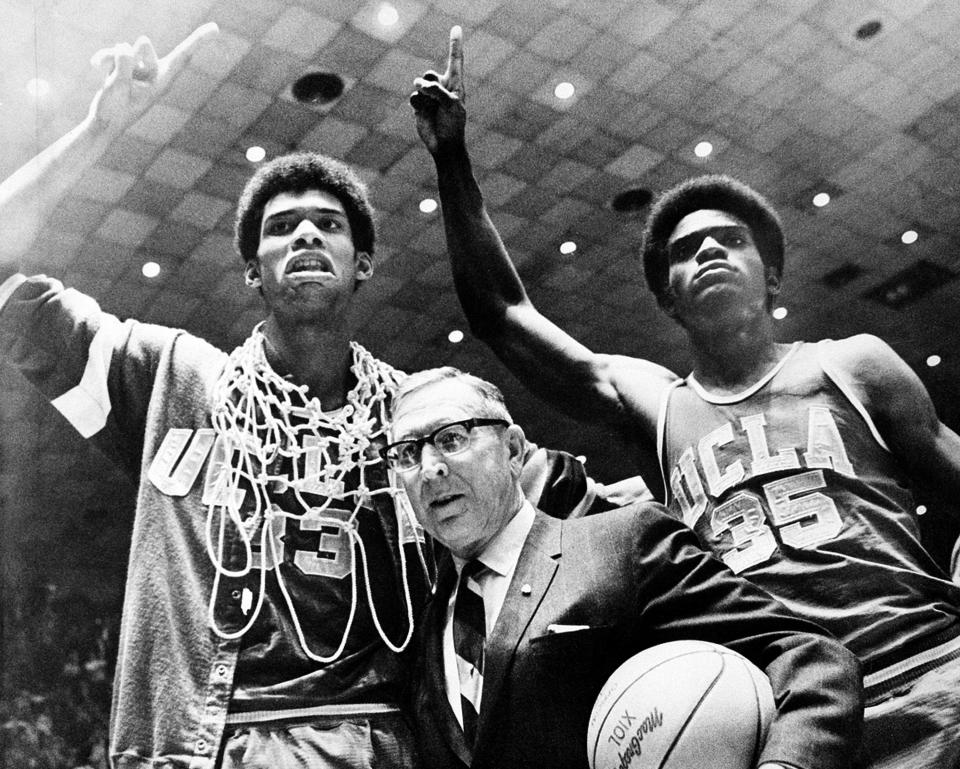 UCLA coach John Wooden is flanked by Sidney Wicks (right), and Kareem Abdul-Jabbar (formerly Lew Alcindor) , after UCLA beat Purdue in the 1969 NCAA Finals.