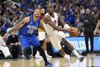 Cleveland Cavaliers guard Caris LeVert, right, drives past Orlando Magic guard Markelle Fultz (20) during the first half of Game 3 of an NBA basketball first-round playoff series Thursday, April 25, 2024, in Orlando, Fla. (AP Photo/John Raoux)