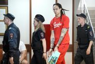 WNBA star and two-time Olympic gold medalist Brittney Griner is escorted to a courtroom for a hearing, in Khimki outside Moscow, Russia, Thursday, July 7, 2022. Griner on Thursday pleaded guilty to drug possession and smuggling during her trial in Moscow but said she had no intention of committing a crime, Russian news agencies reported. (AP Photo/Alexander Zemlianichenko)