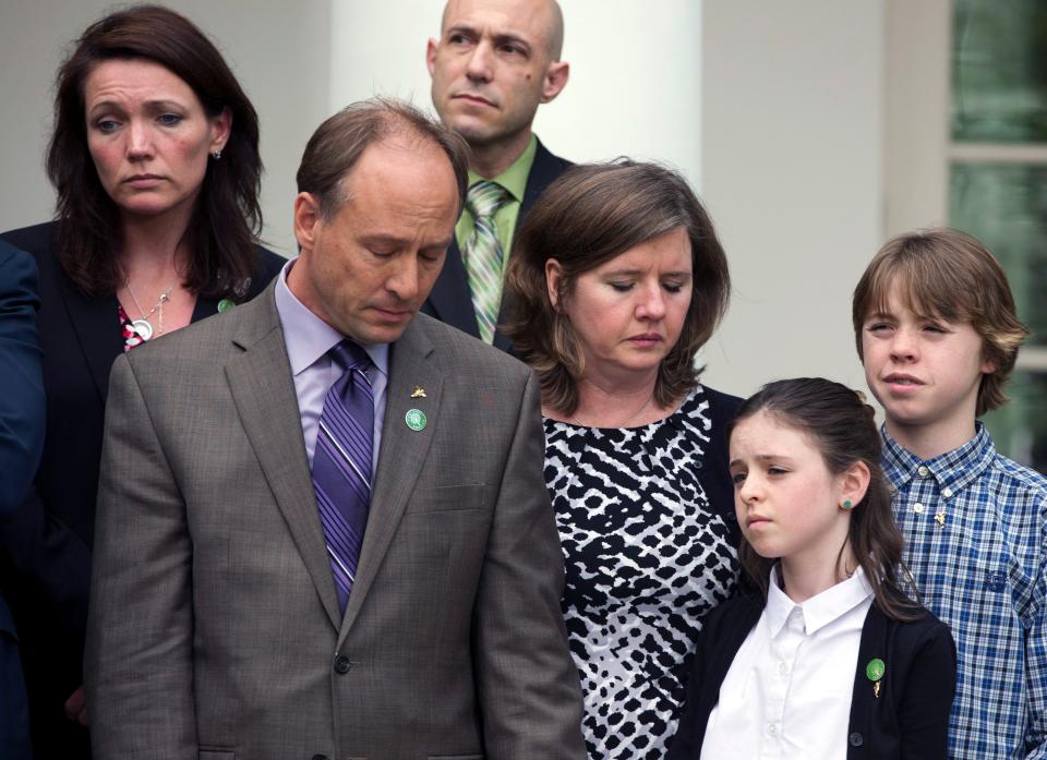 Family members of those lost in the Sandy Hook Elementary School shooting, Mark and Jackie Barden, with their children Natalie and James, who lost Daniel; Nicole Hockley, mother of Dylan, upper left, and and Jeremy Richman, father of Avielle in the back, stand together as President Barack Obama speaks at the White House  on April 17, 2013. Obama spoke about measures to reduce gun violence that were defeated in the Senate.