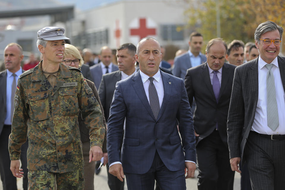 FILE - In this Monday, Nov. 5, 2018 file photo, Kosovo Prime Minister Ramush Haradinaj, center, visits the German KFOR military base in Prizren. Kosovo’s prime minister has resigned from the post after he has been invited to be questioned from a European Union-funded court investigating crimes against ethnic Serbs during and after the 1998-99 independence war with Serbia. Haradinaj said on Friday, July 19, 2019 he had informed the Cabinet of his resignation and urged the country’s president to set a date for an early parliamentary election. (AP Photo/Visar Kryeziu, file)