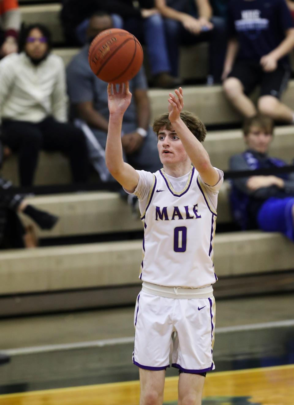 Male’s Cole Edelen (0) shot a jumper against Belfry during their game in the King of the Bluegrass Holiday Classic tournament at the Fairdale High School in Louisville, Ky. on Dec. 18, 2021.