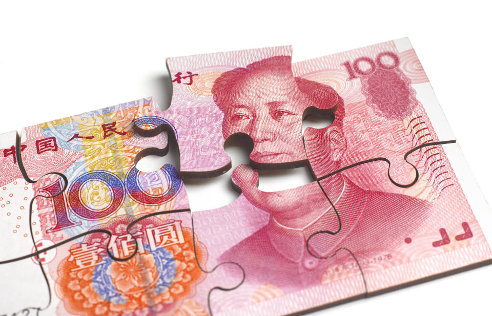 CHINESE 100 YUAN NOTE IN SHAPE OF JIGSAW PUZZLE FALLING APART