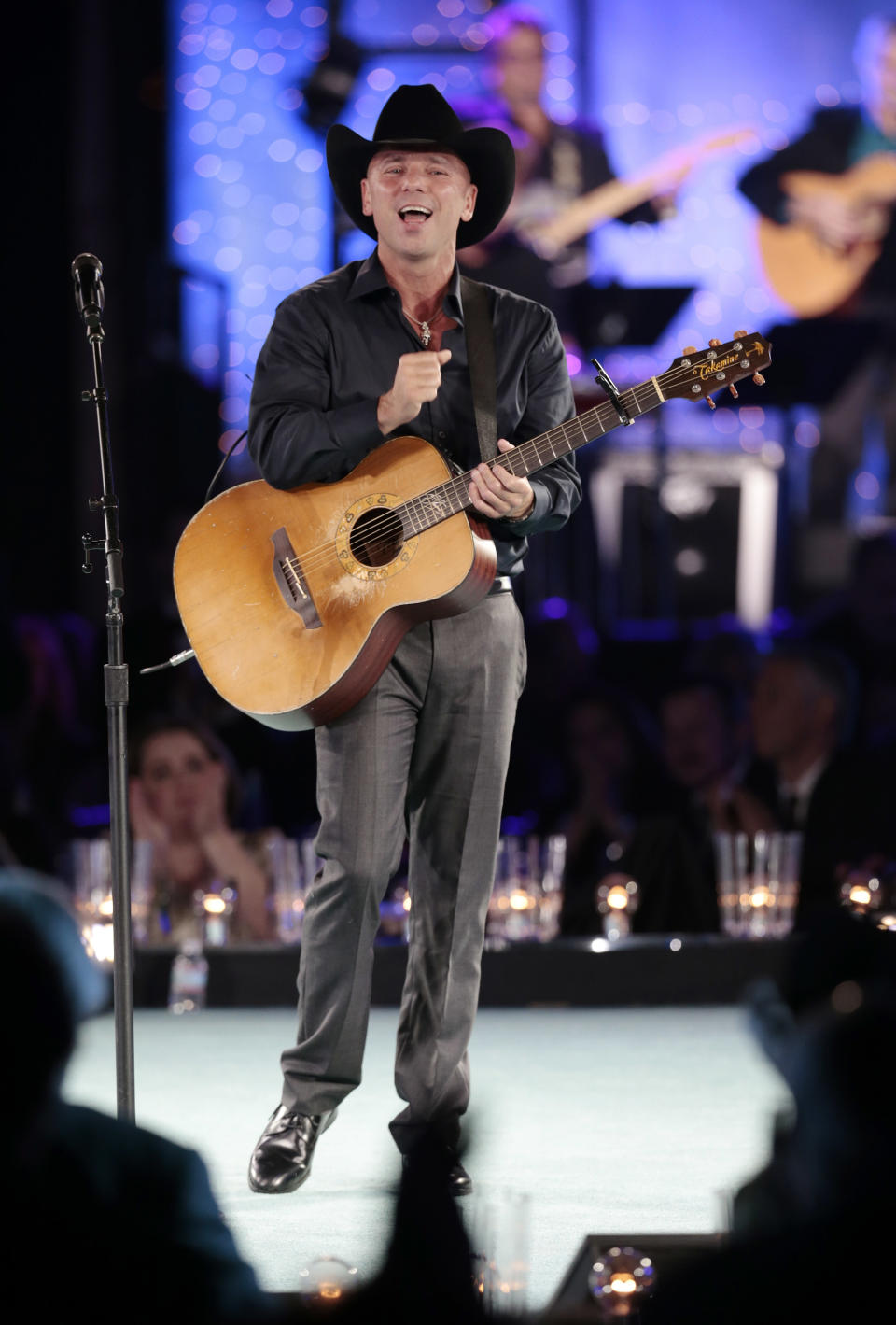 Kenny Chesney performs during a tribute to songwriter Dean Dillon at the BMI Country Awards on Tuesday, Nov. 5, 2013, in Nashville, Tenn. (AP Photo/Mark Humphrey)