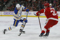 Buffalo Sabres right wing Tage Thompson (72) takes a shot on goal against Detroit Red Wings right wing Carter Rowney (37) during the second period of an NHL hockey game Saturday, Nov. 27, 2021, in Detroit. (AP Photo/Duane Burleson)