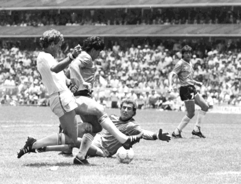 FILE - In this June 22, 1986 file photo, Argentina's Diego Maradona, second left, is about to score his second goal against England, during their World Cup quarte final soccer match, in Mexico City. England's Terry Butcher, left, tries to tackle Maradona, while England's goalkeeper Peter Shilton is on the ground. Argentina won the match 2-1. (AP Photo/File)