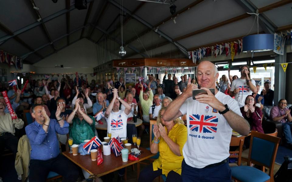 Mike McIntyre celebrates at Hayling Island Sailing Club after his daughter Eilidh and Hannah Mills won Olympic gold - PA