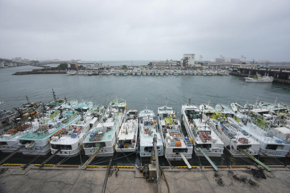 Fishing boats are secured by rope at the Tomari fishery port in Naha in the main Okinawa island, southern Japan, Thursday, June 1, 2023, as a tropical storm was approaching to the Okinawa islands. (AP Photo/Hiro Komae)