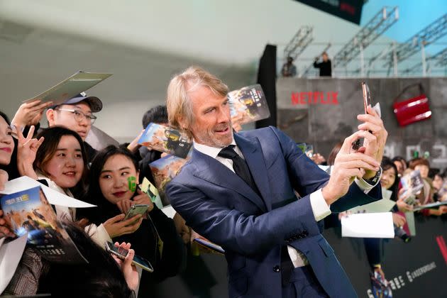 Michael Bay takes a selfie with fans at the world premiere of Netflix's 