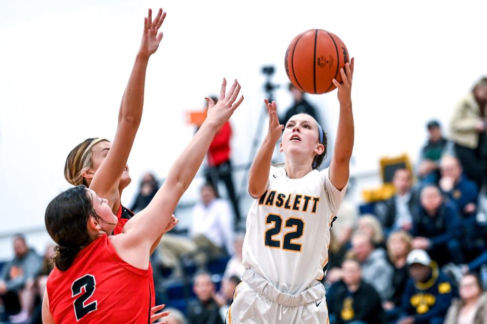 Haslett's Isabel Lindo, right, shoots as Jackson Northwest defends during the first quarter on Tuesday, Nov. 29, 2022, at Haslett High School.