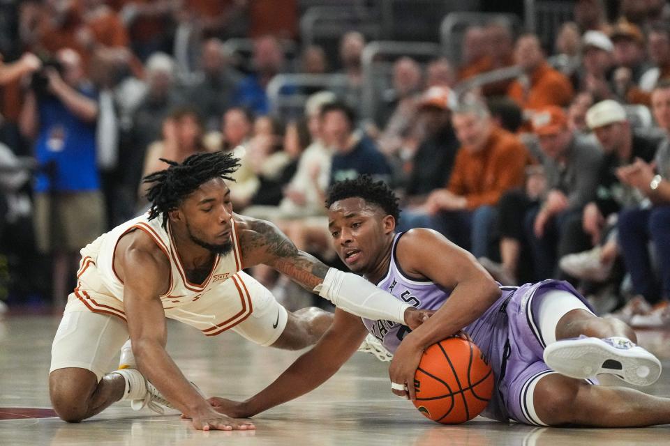 Texas guard Tyrese Hunter, left, battles for a loose ball with Kansas State's Tylor Perry in Monday's 62-56 win at Moody Center. The Horns improved to 6-7 in conference play and will play at Kansas on Saturday. Hunter's defensive energy played a big part in the win.
