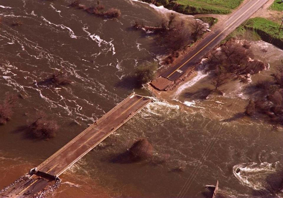 The flooding San Joaquin River wipes out the bridge on Road 206 in Friant on Jan. 19, 1997.