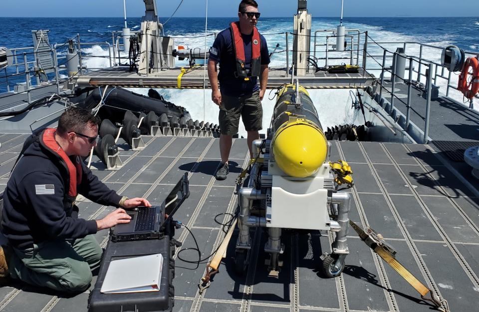 In this handout image from the U.S. Navy, sailors prepare a CARINA unmanned undersea drone off San Diego, California, April 19, 2021. The U.S. Navy's Mideast-based 5th Fleet said Wednesday, Sept. 8, 2021, it will launch a new task force that incorporates airborne, sailing and underwater drones after years of maritime attacks linked to ongoing tensions with Iran. (U.S. Navy/Lt. Cmdr. Tony Wright, via AP)