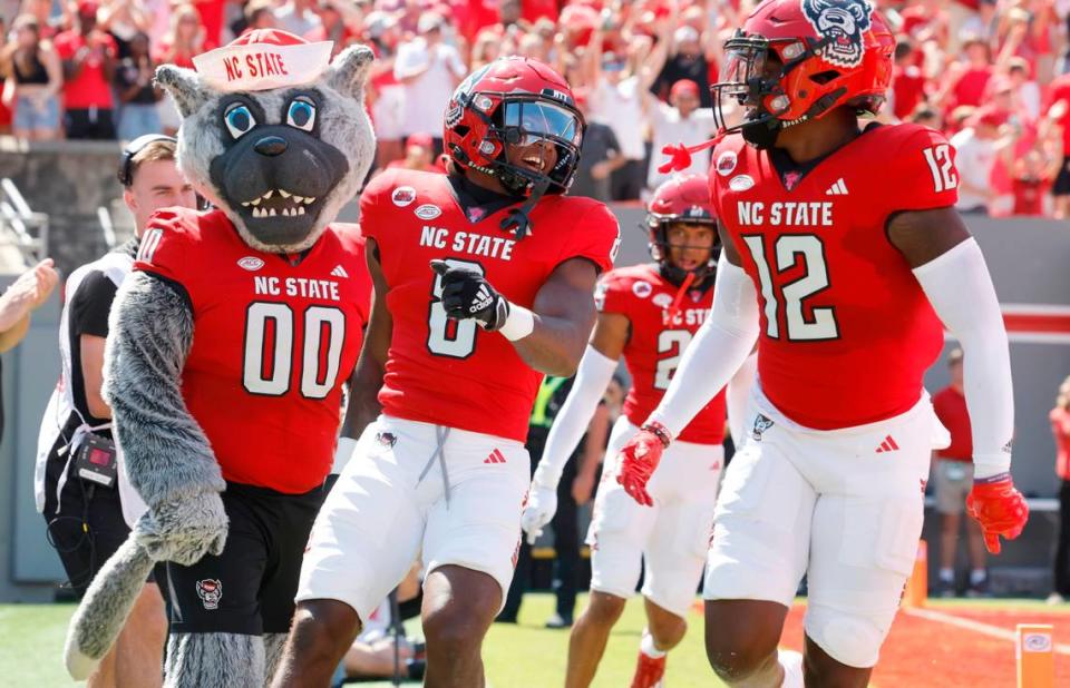 N.C. State defensive back Robert Kennedy (8) celebrates with Devan Boykin (12) after returning an interception for a touchdown during the first half of N.C. State’s game against VMI at Carter-Finley Stadium in Raleigh, N.C., Saturday, Sept. 16, 2023.