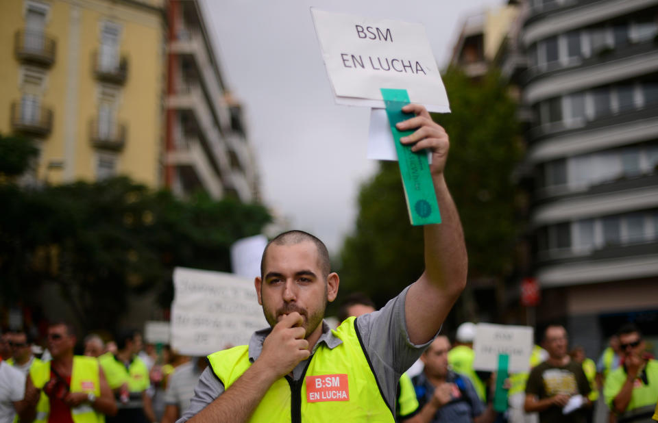 A Government employee protests against cuts in Barcelona, Spain, Monday, July 30, 2012. Spain's borrowing rates hit a record high on Monday, increasing the risk it might need a sovereign bailout, as investors worried the government would be overwhelmed by the debts of its banks and regions. Spain has called for the European Central Bank to take emergency action to ease its government borrowing rates. (AP Photo/Manu Fernandez)