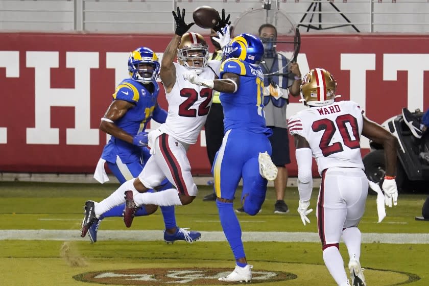 San Francisco 49ers cornerback Jason Verrett (22) intercepts a pass in the end zone between Los Angeles Rams wide receiver Robert Woods, left, and Josh Reynolds during the second half of an NFL football game in Santa Clara, Calif., Sunday, Oct. 18, 2020. (AP Photo/Tony Avelar)