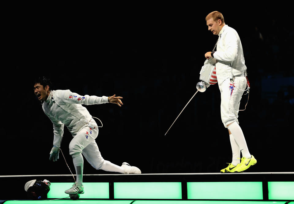LONDON, ENGLAND - AUGUST 01: (L-R) Jinsun Jung of Korea left celebrates victory in the Men's Epee Individual Fencing Bronze medal match against Seth Kelsey of the United States on Day 5 of the London 2012 Olympic Games at ExCeL on August 1, 2012 in London, England. (Photo by Hannah Johnston/Getty Images)