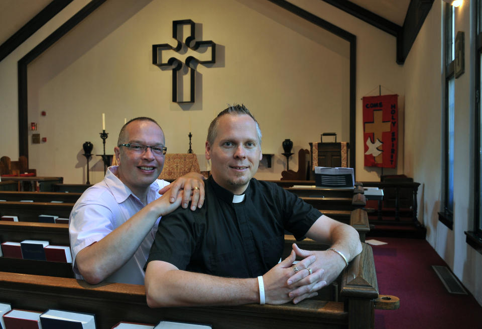 FILE - The Very Rev. Christopher D. Hofer, right and his partner of 17 years, Kerry Brady at Hofer's parish, the Episcopal Church of St. Jude on Thursday, July 14, 2011 in Wantagh, N.Y., where they plan to wed in August. When the United Methodist Church removed anti-LGBTQ language from its official rules in recent days, it marked the end of a half-century of debates over LGBTQ inclusion in mainline Protestant denominations. The moves sparked joy from progressive delegates, but the UMC faces many of the same challenges as Lutheran, Presbyterian and Episcopal denominations that took similar routes, from schisms to friction with international churches to the long-term aging and shrinking of their memberships. (AP Photo/Kathy Kmonicek)