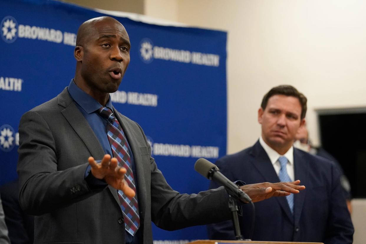 Florida Surgeon General Dr. Joseph Ladapo, left, speaks at a news conference with Florida Gov. Ron DeSantis, right, at Broward Health Medical Center in Fort Lauderdale.