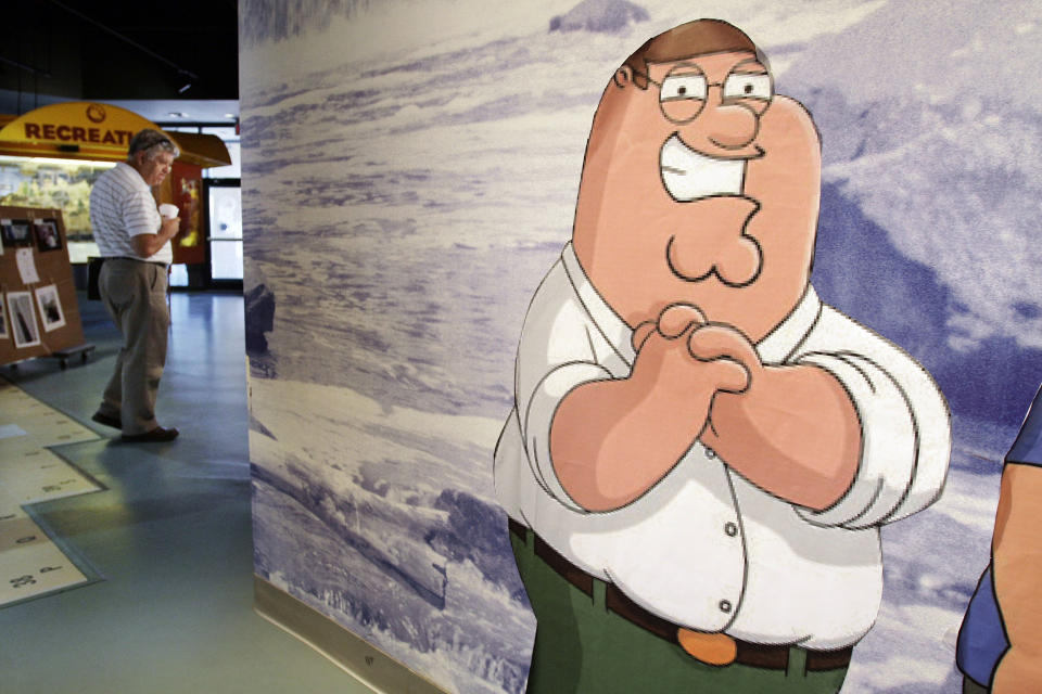 In this Sept. 23, 2010 photo, a likeness of cartoon character Peter Griffin, from the Fox animated program the "Family Guy" stands in the Rhode Island Visitor's Center, in Pawtucket, R.I. Fans of the show, based in the fictional Rhode Island town of Quahog, can hit the road on a bus tour highlighting a dozen sites in the state that have served as inspiration. (AP Photo/Steven Senne)