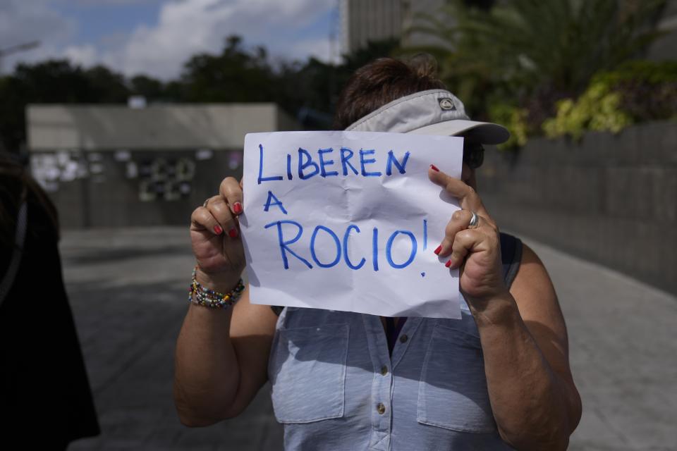 A protester holds a sign that reads in Spanish "Release Rocio!," referring to arrested activist Human Rights lawyer and activist Rocio San Miguel, on the sidelines of a press conference about her detention the previous week, outside office of the UN Development Program (PNUD) in Caracas, Venezuela, Wednesday, Feb 14, 2024. Rocio San Miguel is accused by the government of terrorism for allegedly plotting to kill President Nicolas Maduro. (AP Photo/Ariana Cubillos)