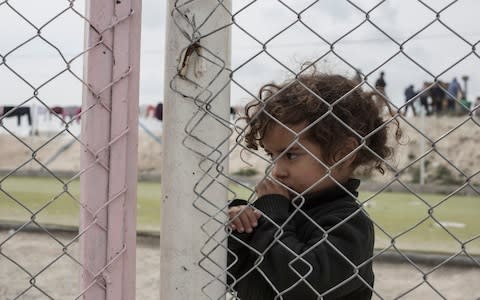 A girl stands in the section for foreign families at a camp for people who lived under ISIS and are now displaced, in Al Hol, near Hasakeh in Syria