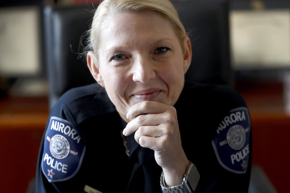 In this Monday, April 20, 2020, photo Aurora, Ill. police chief Kristen Ziman smiles as she poses for a portrait at her office in Aurora. Across the country first responders who've fallen ill and recovered, like Chief Ziman, have begun the harrowing experience of returning to jobs that put them back on the front lines of America's fight against the novel coronavirus. (AP Photo/Charles Rex Arbogast)