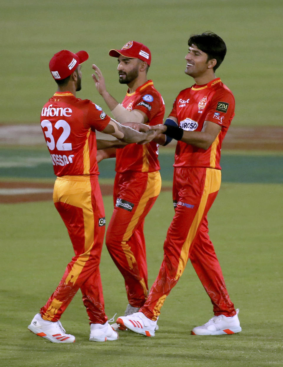Islamabad United's Mohammad Wasim, right, celebrates with teammates after taking the wicket of Multan Sultans' Shahid Afridi during a Pakistan Super League T20 cricket match between Multan Sultans and Islamabad United at the National Stadium, in Karachi, Pakistan, Sunday, Feb. 21 2021. (AP Photo/Fareed Khan)