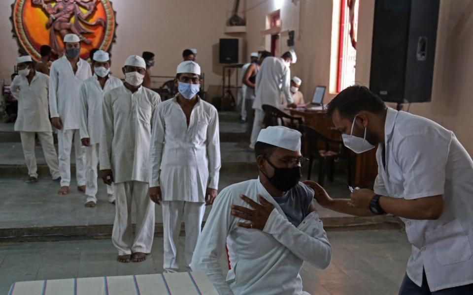 In Bhopal, India, an inmate is inoculated with a dose of Covishield Covid vaccine as a vaccination drive picks up pace at the central jail - GAGAN NAYAR/AFP via Getty Images