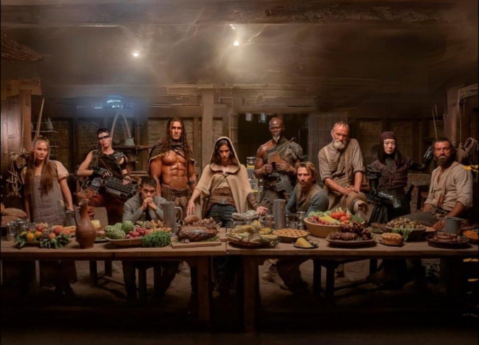 a group of people arranged around a table heaped with food