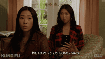 Two women sitting on a couch while one says, "we have to do something"
