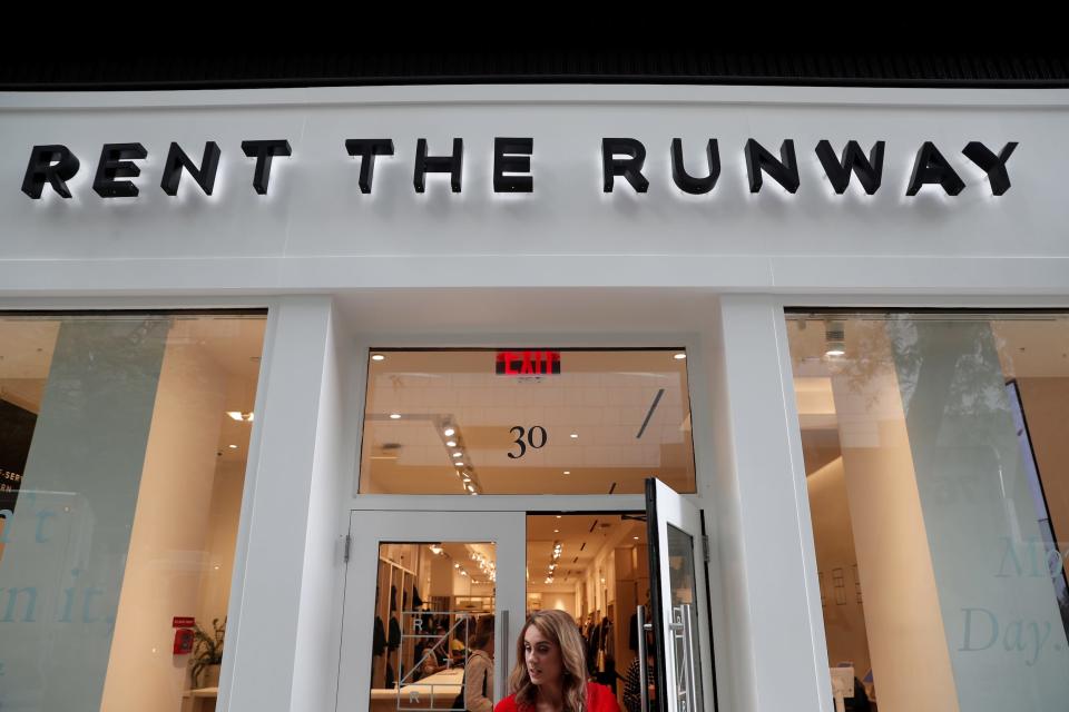 Woman walks out the door of Rent the Runway store