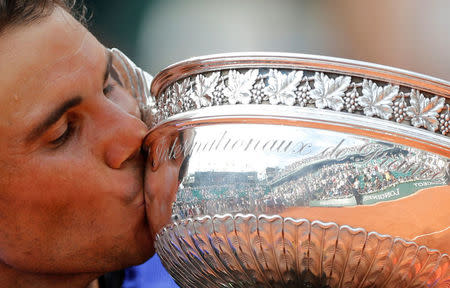 FILE PHOTO: Tennis - French Open - Roland Garros, Paris, France - June 11, 2017 Spain's Rafael Nadal kisses the trophy as he celebrates after winning the final Picture taken June 11, 2017. Reuters/Benoit Tessier