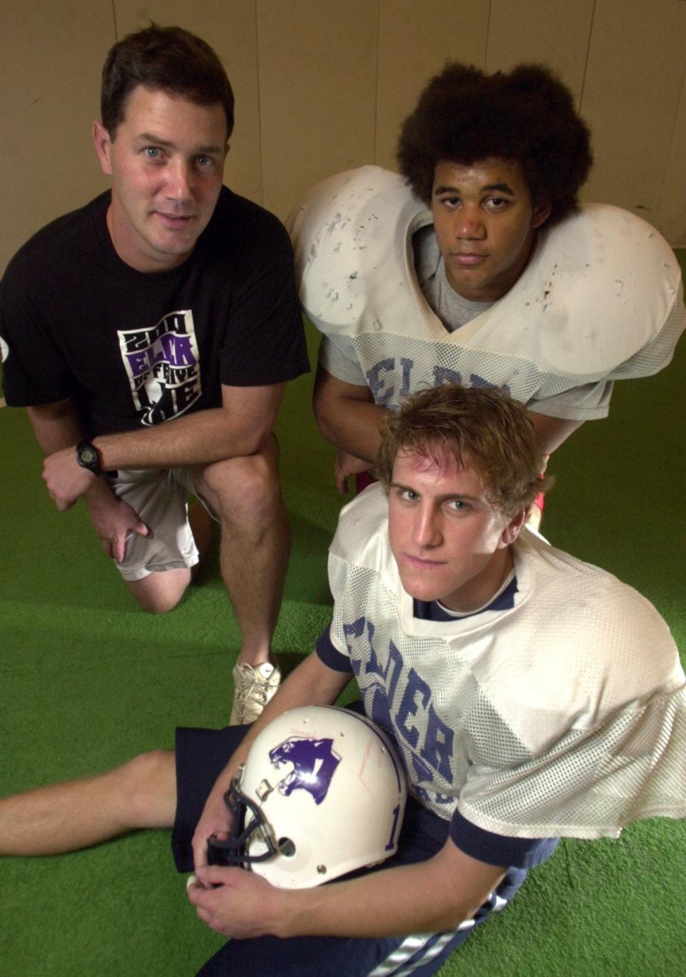 Elder High School head football coach Doug Ramsey, rear left, photographed with players, Rob Florian, quarterback, front, and Bradley Glatthaar, running back, rear right, during a break in practice Tuesday November 18, 2003 at The Western Sports Mall.