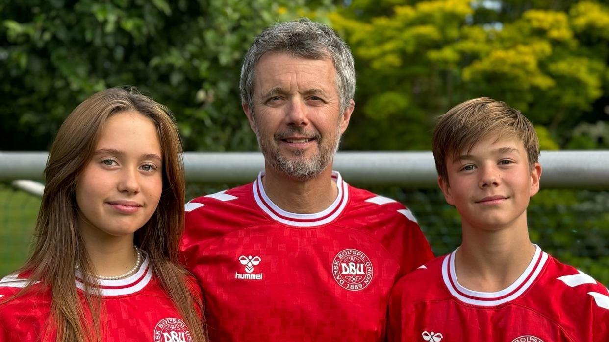 King Frederik with Princess Josephine and Prince Vincent in red Danish football tops