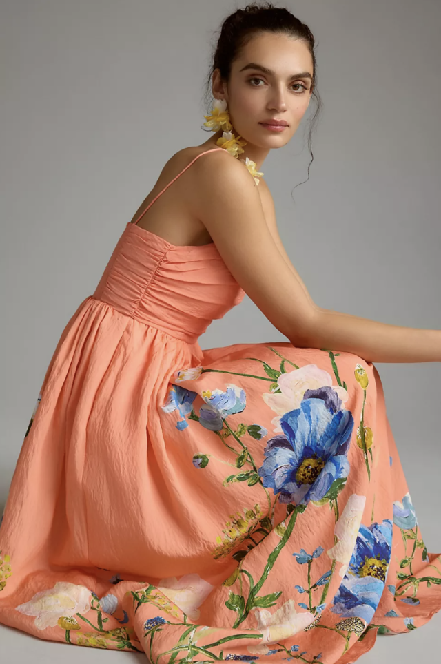model wearing peach and floral The Lorelei Ruched-Bodice Midi Dress (photo via Anthropologie)