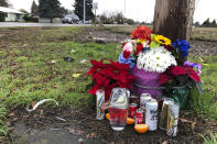 Flowers, candles, and other objects are shown at a memorial, Thursday, Dec. 12, 2019, at the scene where three Christmas tree farm workers from Guatemala were killed and others were injured in a van crash on Nov. 29, 2019 in Salem, Ore. Immigrant and worker advocates say the crash shed light on "invisible work" by immigrant workers that takes place in Oregon, which has the U.S.'s largest Christmas tree industry. (AP Photo/Andrew Selsky)