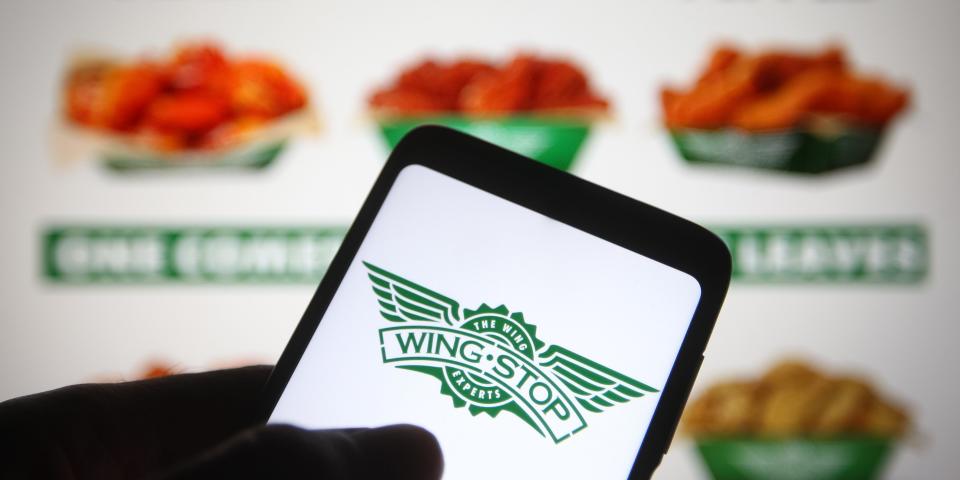 UKRAINE - 2021/06/21: In this photo illustration a Wingstop logo of an US chain of restaurants is seen on a smartphone screen with a Wingstop menu in the background. (Photo Illustration by Pavlo Gonchar/SOPA Images/LightRocket via Getty Images)