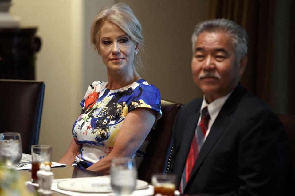 White House counselor Kellyanne Conway, left, and Hawaii Gov. David Ige listen as President Donald Trump speaks during a meeting with governors on "workforce freedom and mobility" in the Cabinet Room of the White House, Thursday, June 13, 2019, in Washington. (AP Photo/Evan Vucci)