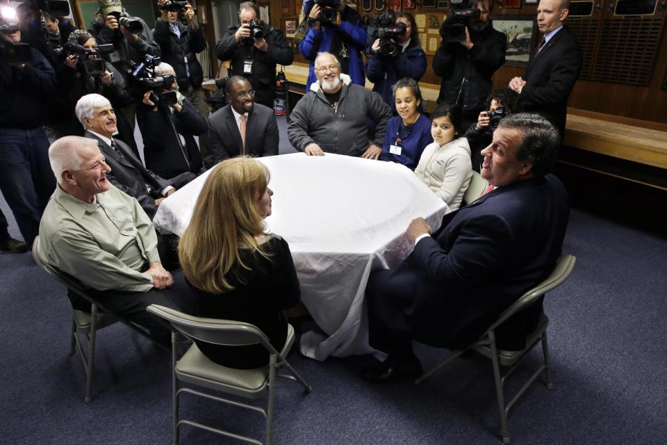 New Jersey Gov. Chris Christie, right, sits with a small group of home owners, who lost their homes in last year's Superstorm Sandy, and officials Thursday, Jan. 16, 2014, in Manahawkin, N.J. Christie spoke to Superstorm Sandy victims one week after the meeting was hastily canceled because of a scandal over traffic jams that appear to have been manufactured by his aides. Christie and Community Affairs Commissioner Richard Constable III announced a Sandy housing recovery milestone Thursday as the governor seeks to put the traffic scandal behind him. (AP Photo/Mel Evans)