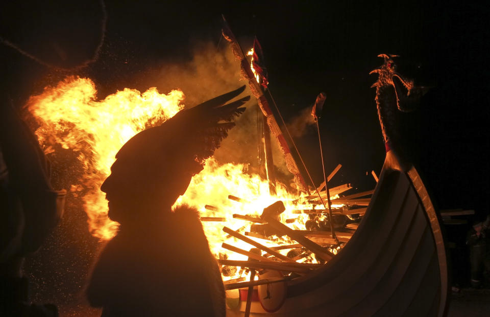 In this photo taken March 14, 2014, a man dressed as a Viking is silhouetted against a burning mock Viking ship as they take part in the annual Up Helly Aa, Viking fire festival in Gulberwick, Shetland Islands north of mainland Scotland. The fearsome-looking participants in the festival live in Scotland's remote Shetland Islands, a wind-whipped northern archipelago where many claim descent from Scandinavian raiders. They are cool to the idea of Scotland leaving Britain to form an independent nation, and determined that their rugged islands will retain their autonomy whatever the outcome of September’s referendum. (AP Photo/Jill Lawless)