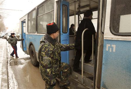 Russian Cossacks, who started regular patrols within the city in the wake of recent suicide attacks, board a trolley bus while patrolling the streets in the southern Russian city of Volgograd, January 4, 2014. REUTERS/Vasily Fedosenko